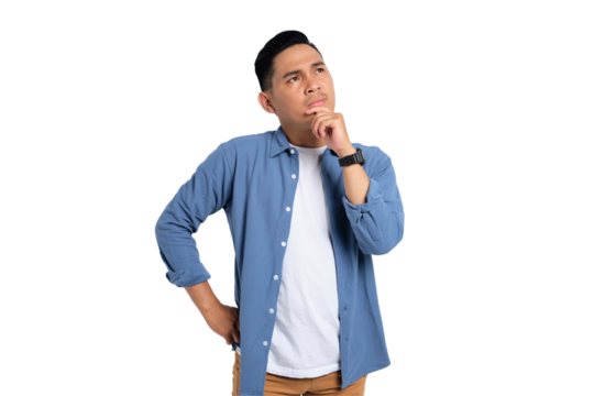Pensive young Asian man in casual shirt touching his chin, looking up at copy space, having doubts about something isolated on transparent background