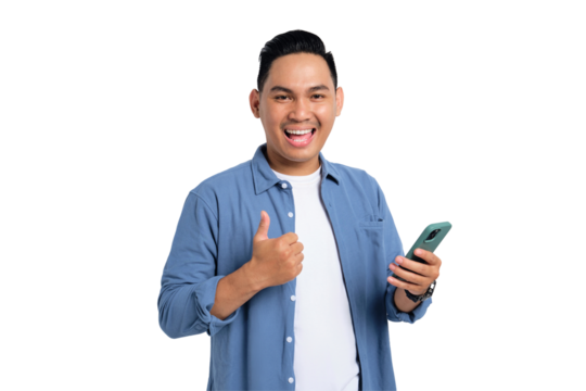 Smiling young Asian man in casual shirt using smartphone and showing thumbs up isolated on transparent background