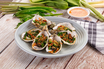 Gournet grilled oysters with onion and peanut