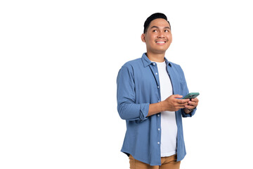 Doubtful young Asian man in casual shirt holding smartphone, looking aside at free space, thinking...