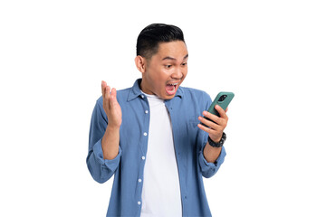 Overjoyed young Asian man in casual shirt reading good news on mobile phone with surprised facial...