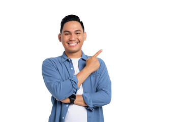 Smiling young Asian man in casual shirt pointing fingers aside at copy space for your advertisement...