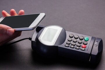 Man using smartphone to express pay