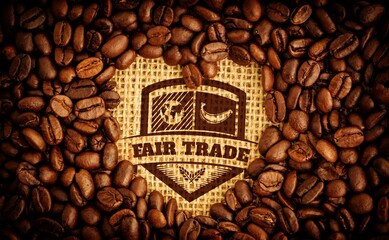 Flat design is portraying burlap tearing open to show Fair Trade emblem surrounded by coffee beans