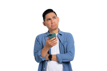 Pensive young Asian man in casual shirt holding smartphone, looking aside at copy space, thinking about offer isolated on transparent background