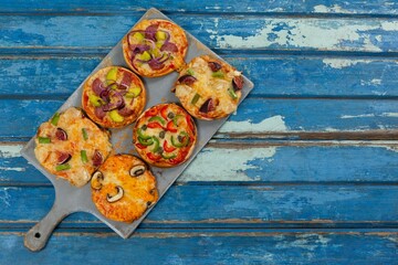 Pizzas arranged on wooden table © vectorfusionart
