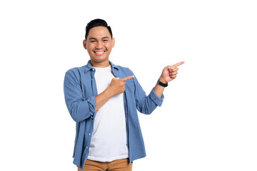 Smiling young Asian man in casual shirt pointing fingers aside at copy space for your advertisement isolated on transparent background