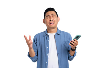 Unhappy young Asian man in casual shirt holding smartphone, receiving negative message, sad facial...
