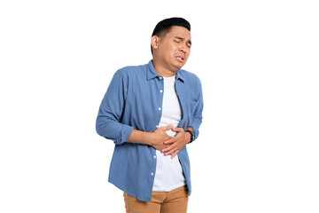 Abdominal Pain. Unhealthy young Asian man in casual shirt suffering from stomachache isolated on...