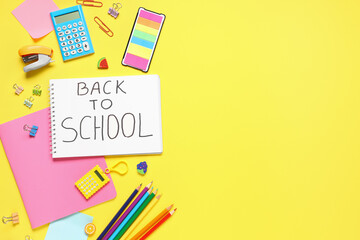 Notebook with text BACK TO SCHOOL and different stationery on yellow background