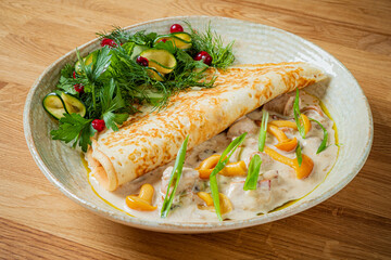 Savory crepe brimming with a rich filling, elegantly arranged with vibrant greens and fresh herbs