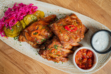 Grilled chicken with pickled veggies and tasty sauces makes a delicious meal