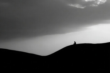 minimalist photograph human silhouette on rice terraces in indonesia under dramatic storm clouds