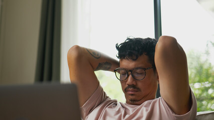 Asian man suffering neck pain after long hours of work.