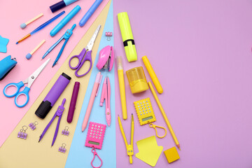 School supplies with scissors, markers and dividers on colorful background. Top view
