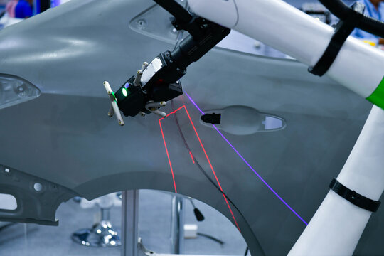 3D scanner on robotic arm measure the accuracy of automotive parts. in industrial plants
