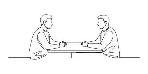 Two businessmen are sitting at a table and having a conversation