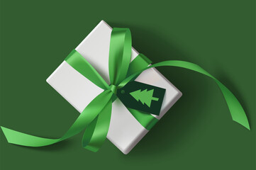 New year white gift box with green bow and label with Christmas fir shape on green background. Christmas and new year holiday decoration. Vector stock illustration.
