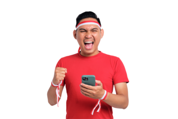 Excited young Asian men celebrate Indonesian independence day on 17 August while holding mobile phone isolated on transparent background