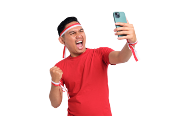 Excited young Asian men celebrate Indonesian independence day on 17 August while holding mobile phone isolated on transparent background