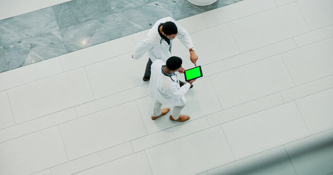 Men, doctor and medical team with tablet screen at hospital for research and development above. Top view, male people or healthcare employees walking with technology display or mockup space for app