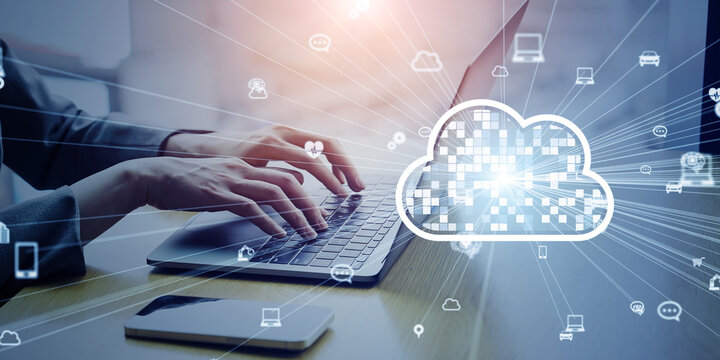 Cloud computing concept with business people using laptops in office