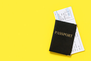 Passport with ticket on yellow background