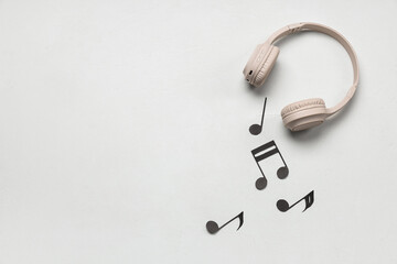 Headphones with notes on white grunge background