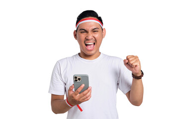 Excited young Asian man celebrate Indonesian independence day on 17 August while holding mobile...