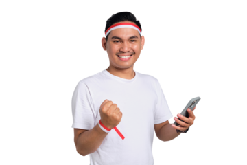 Excited young Asian man celebrate Indonesian independence day on 17 August while holding mobile phone isolated on transparent background