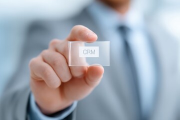 Businessman Holding Transparent Card with CRM Text in Modern Office Setting