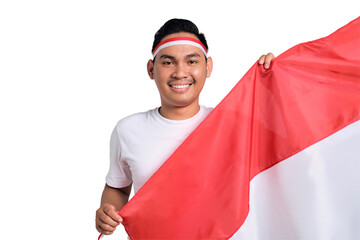 Happy young Asian man celebrate Indonesian independence day on 17 August while holding the...