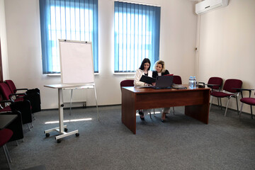 Two women meet to discuss a project and sign a contract.