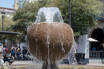 Guadalajara, Mexico - March 24 2025: Detailed view of flowing water from a spherical stone fountain...