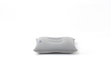 A minimalist shot of a gray inflatable travel pillow on a clean white background