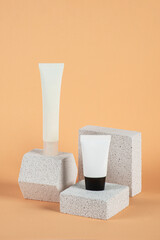 Plastic white tube for cream or lotion. Skin care or sunscreen cosmetic with stylish props on cream...