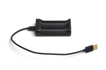 A black battery charger with its USB cable is placed on a clean white background