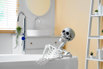 Skeleton lying in bathtub at home