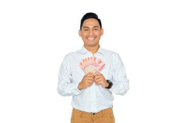 Finance concept. Smiling young Asian man in formal wear holding money and looking at camera with happy expression isolated on transparent background
