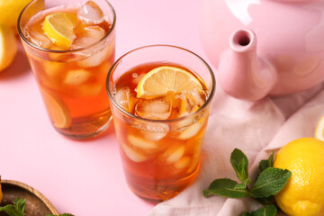 Glasses of fresh iced tea on pink background, closeup