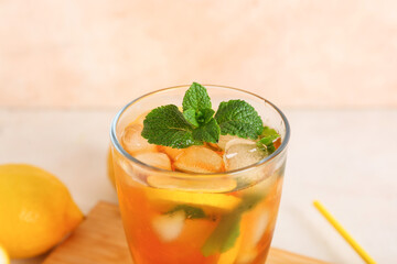 Glass of fresh iced tea on table, closeup