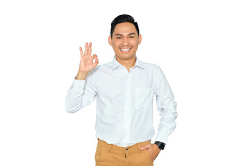 Portrait of happy young Asian man in formal wear showing ok sign with finger and looking at camera...