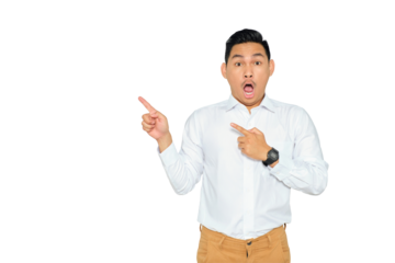 Portrait of surprised young Asian man in formal wear pointing fingers aside at copy space, presents something isolated on transparent background