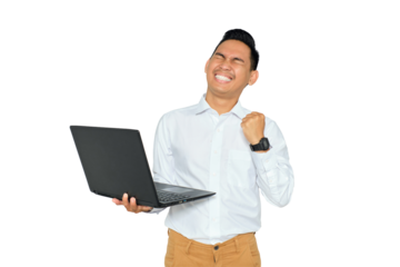 Portrait of excited young Asian man in formal wear holding laptop and making winner gesture with clenched fist isolated on transparent background