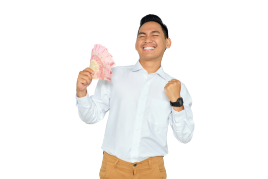 Wealth concept. Excited young Asian man in formal wear holding money and celebrating success with raised fist isolated on transparent background