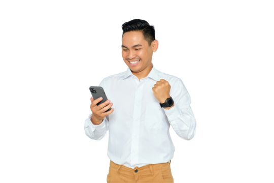 Happy young Asian man in formal wear using mobile phone for trading or chatting and making winning gesture isolated on transparent background