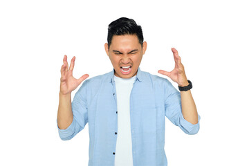 Portrait of angry young Asian man in casual clothes raising hands and screaming with aggressive...