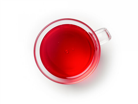 Top down view of a glass mug filled with a vibrant red liquid on white surface