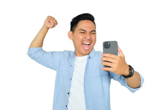 Happy young Asian man in casual clothes using mobile phone for trading or chatting and making winning gesture isolated on transparent background