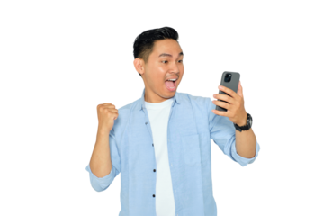 Happy young Asian man in casual clothes using mobile phone for trading or chatting and making winning gesture isolated on transparent background